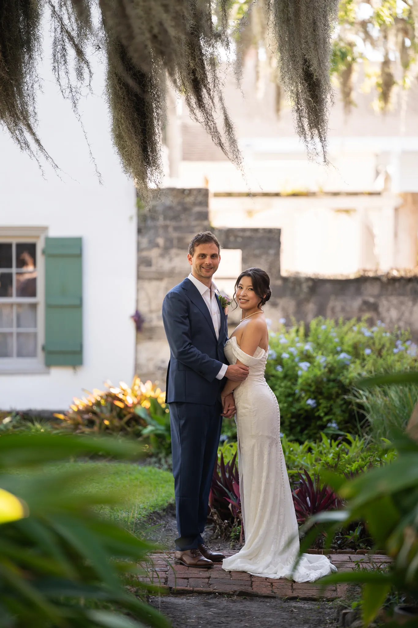 Couple portrait under Spanish moss in the garden at the Oldest House