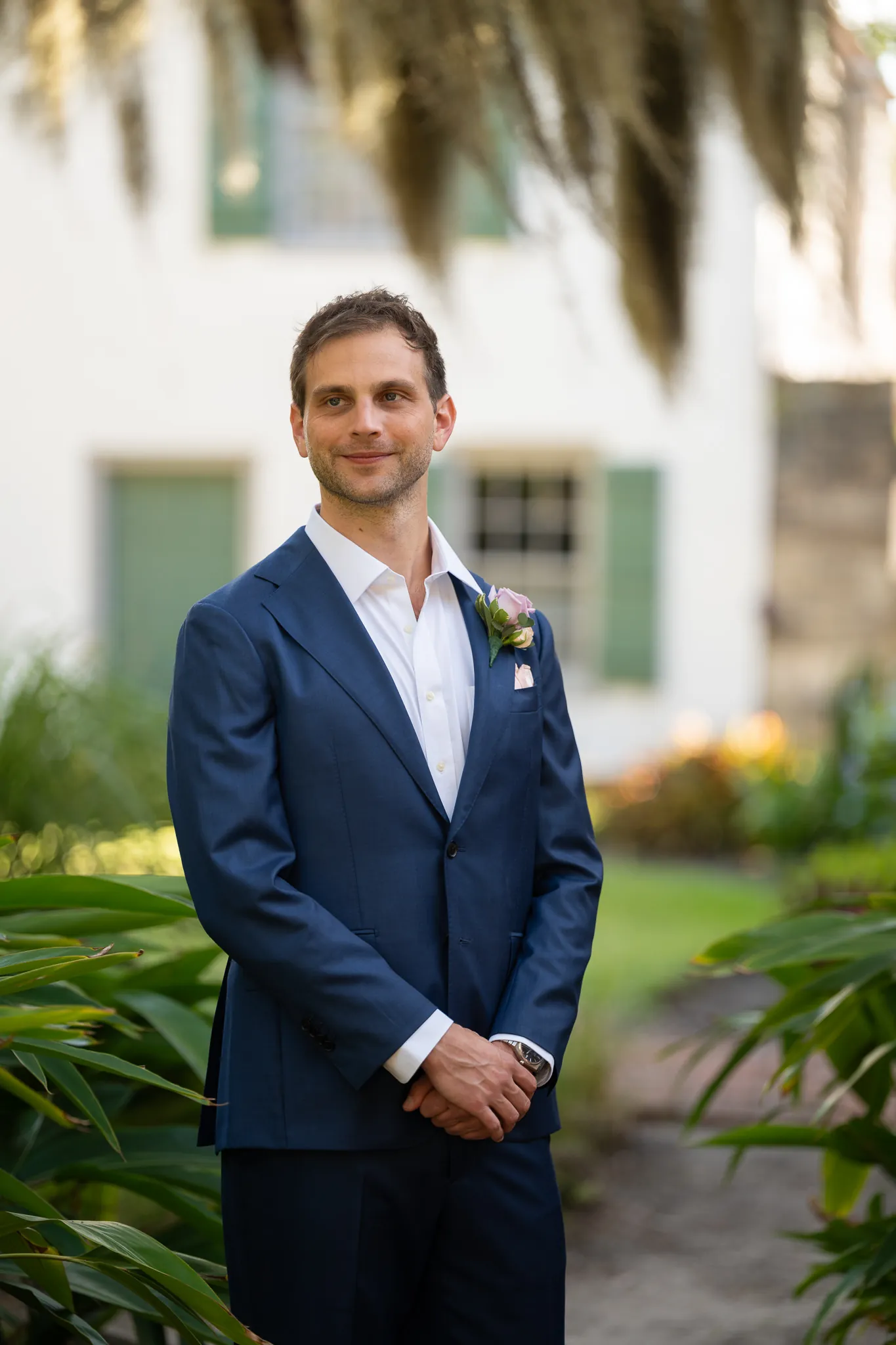 Groom Nico portrait in the garden at the Oldest House St. Augustine