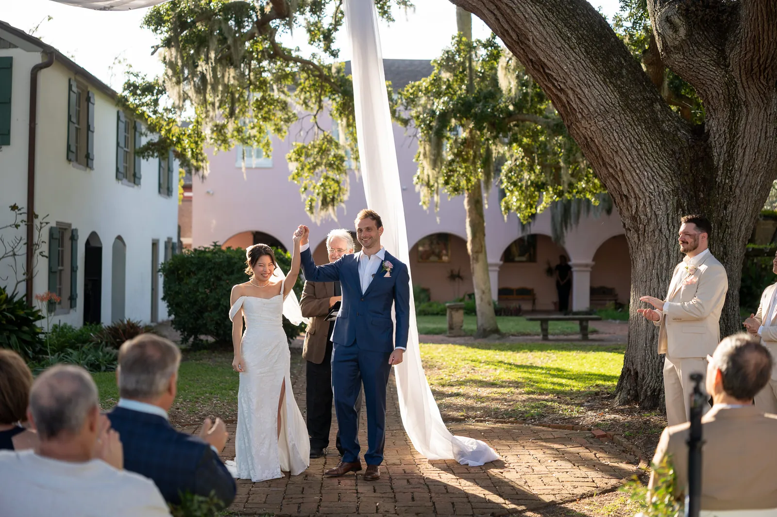 Binh and Nico announced as married under oak tree with Spanish moss