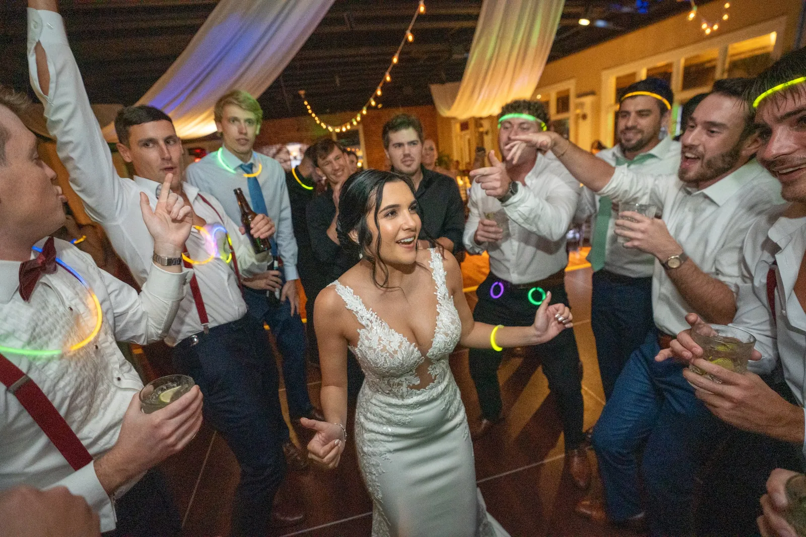 Bride Bri dancing with groomsmen and glow sticks at The White Room party