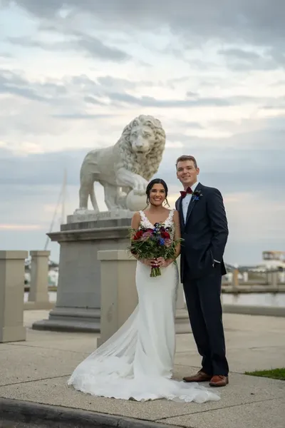 Bri and Nick portrait with lion statue at Bridge of Lions St. Augustine