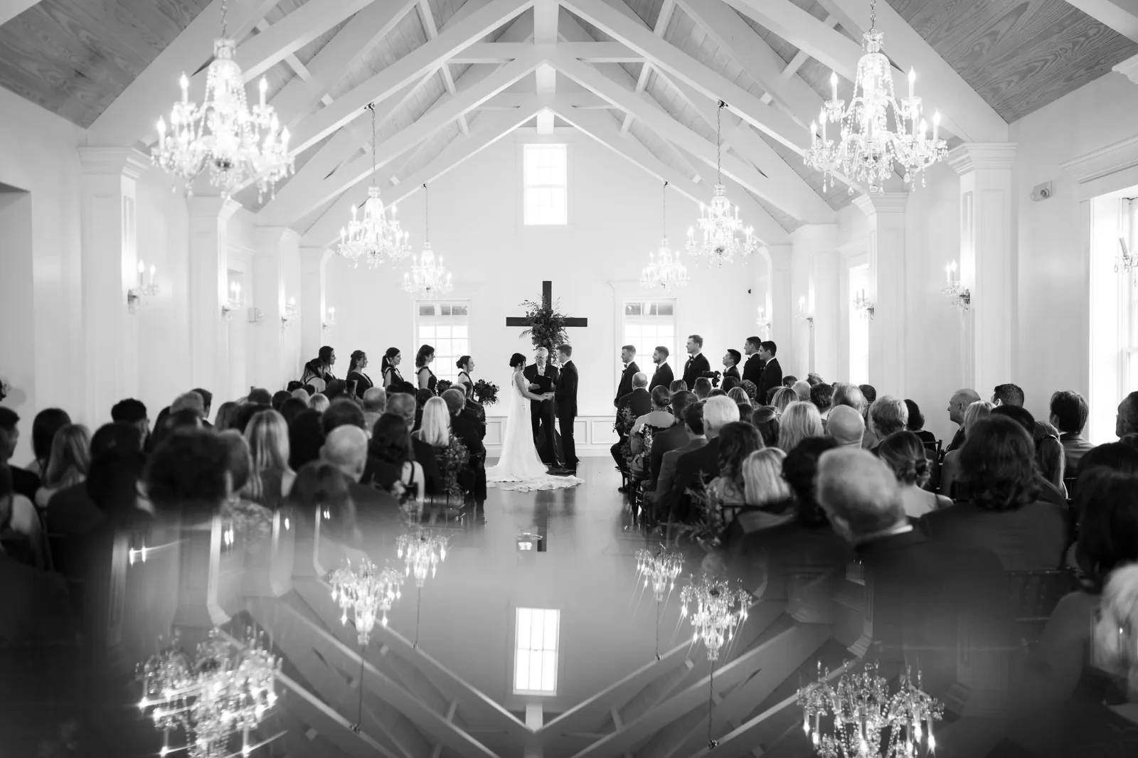 Wedding ceremony wide shot with crystal chandeliers black and white at The White Room chapel