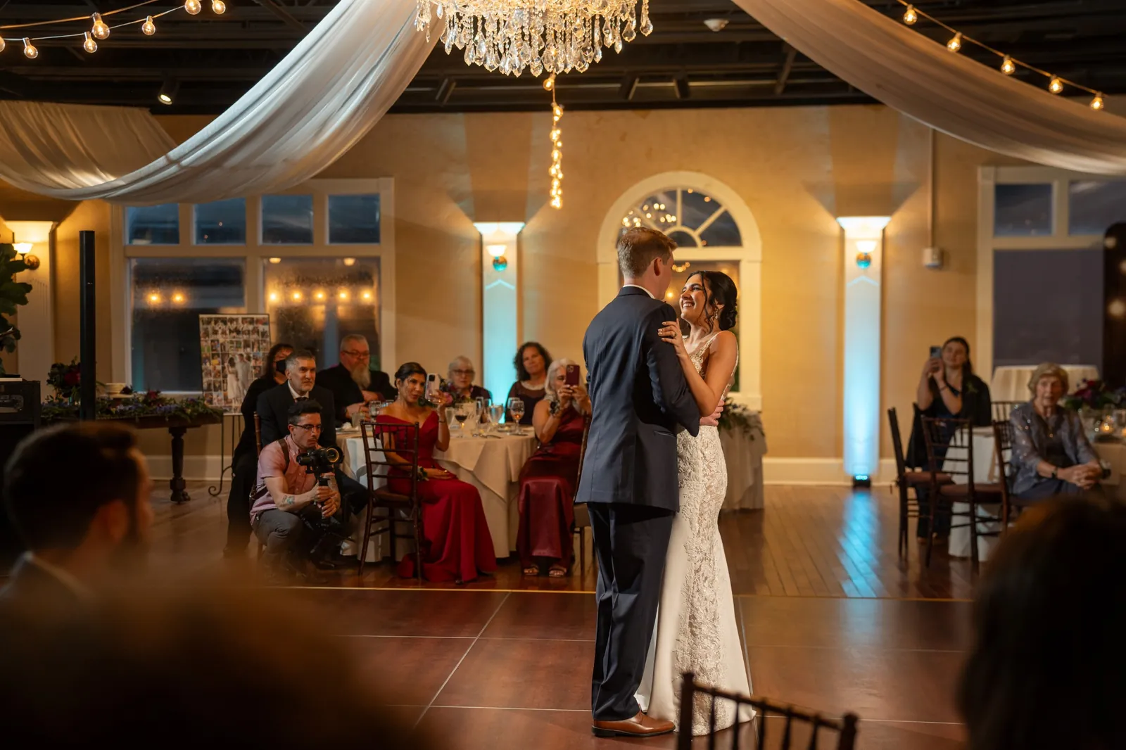 First dance wide shot with chandelier and draping at The White Room