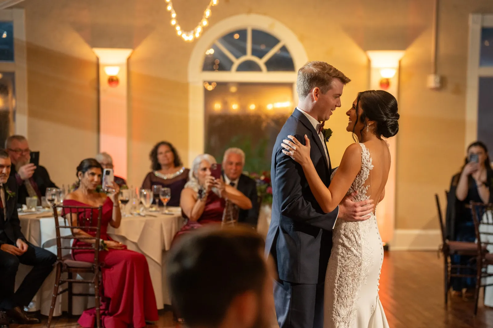 Bri and Nick first dance with string lights at The White Room reception