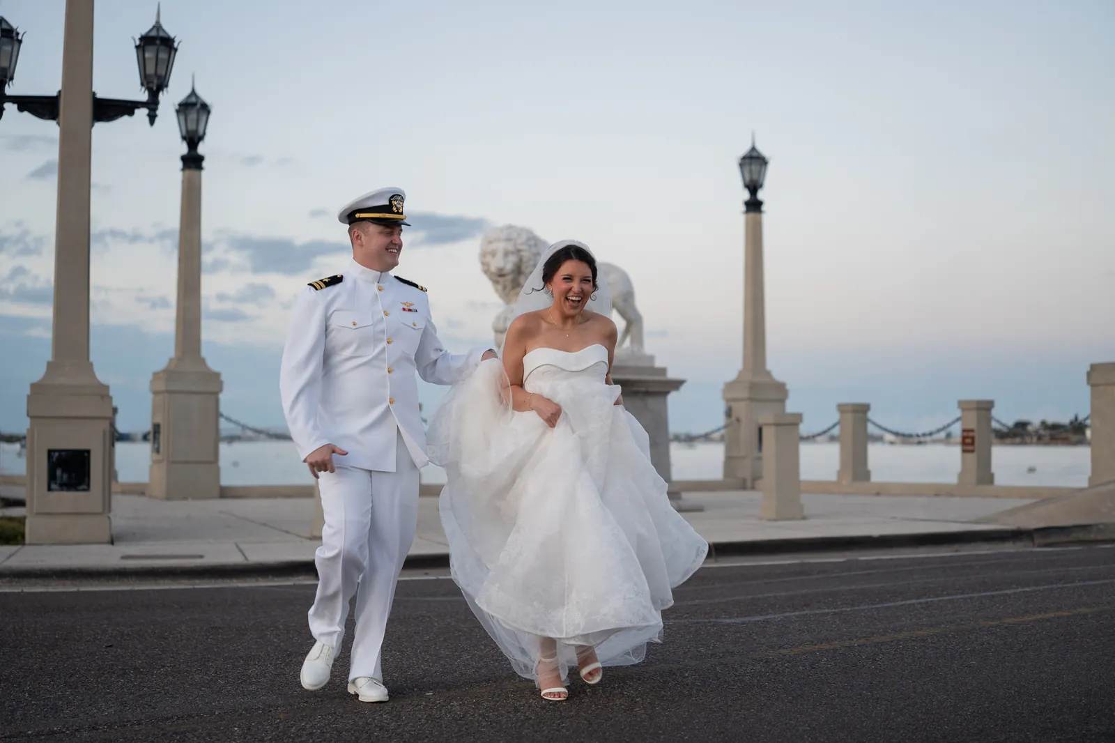 Bride and groom laughing at Bridge of Lions in St. Augustine
