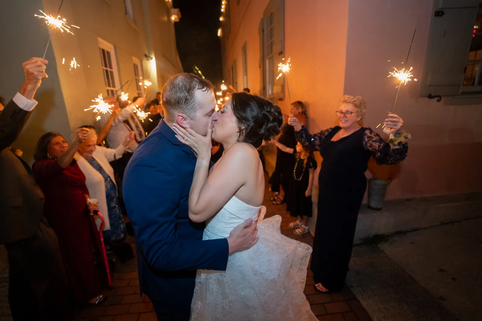 Bride and groom sparkler exit kiss