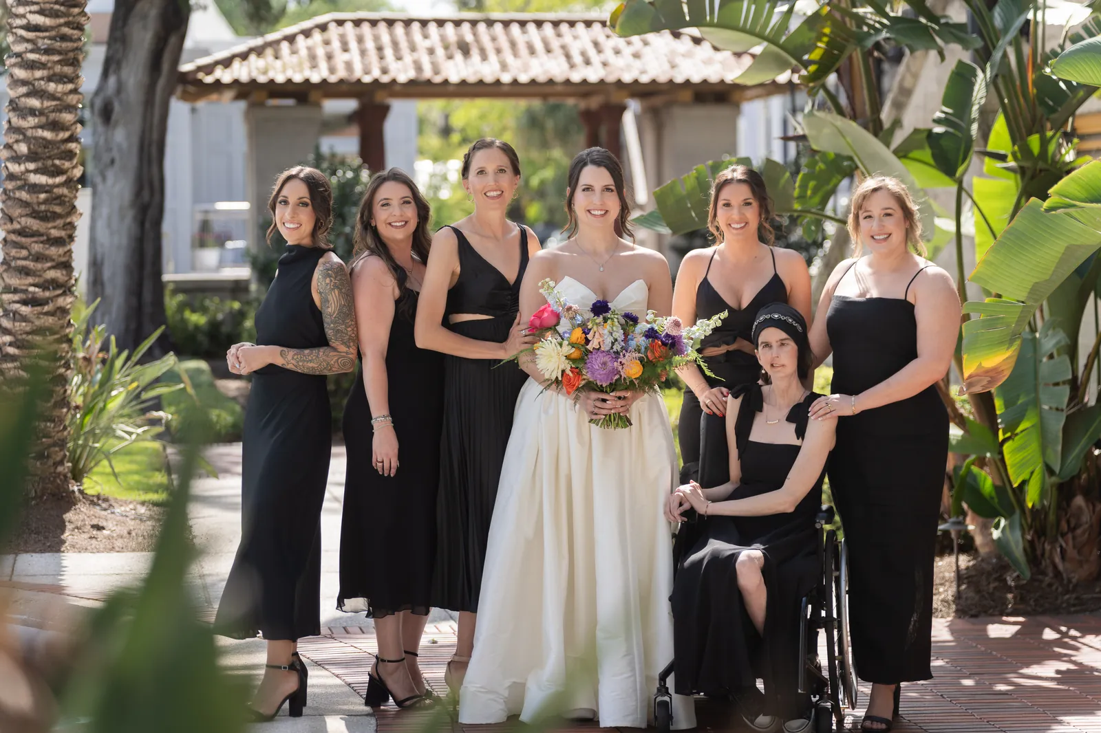 Bridesmaids in black dresses in Lightner Museum courtyard