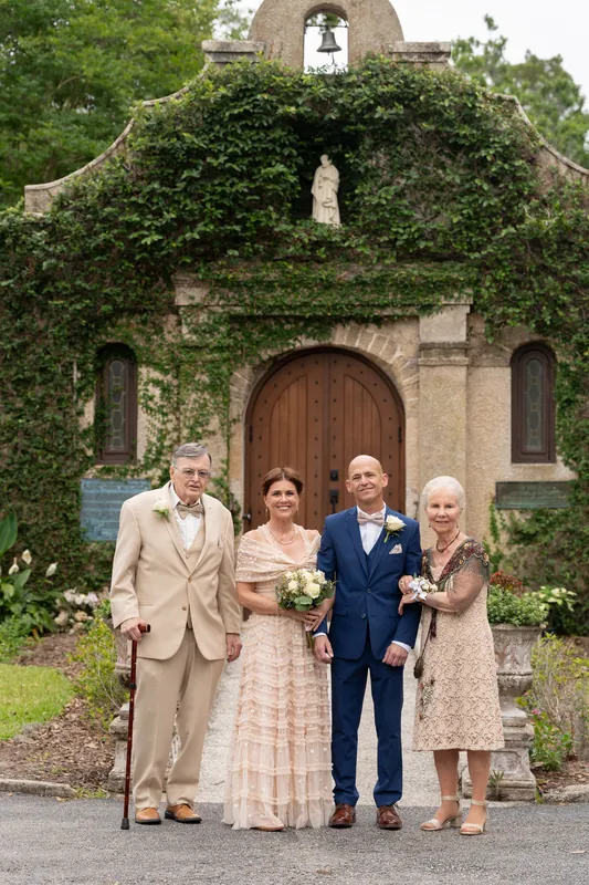 Dan, Bridgid, and two family members pose together with the shrine's verdant entrance and bell tower visible behind them.