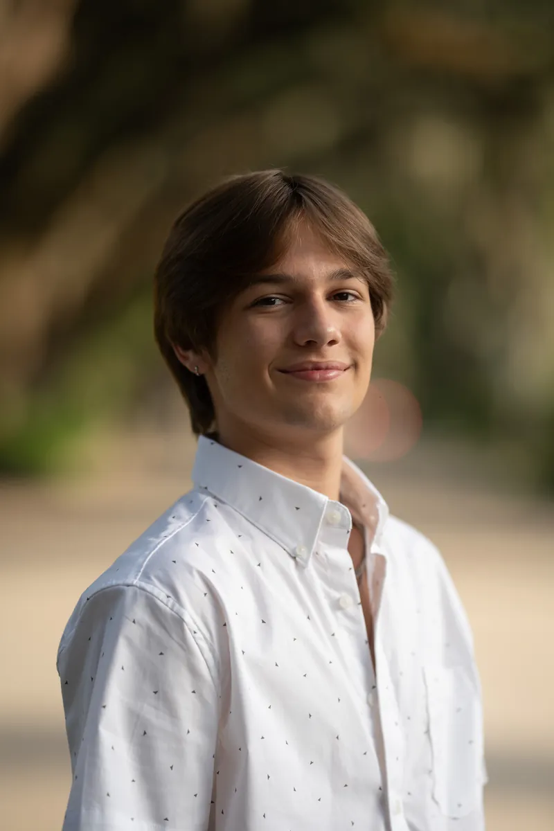 Close-up portrait of teenage boy in white button-down shirt