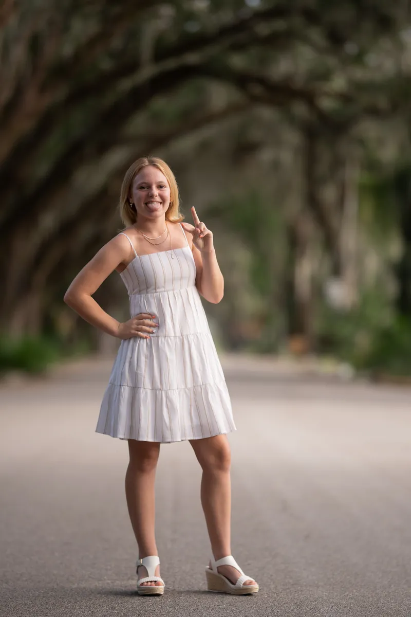 Younger sister making peace sign with playful expression
