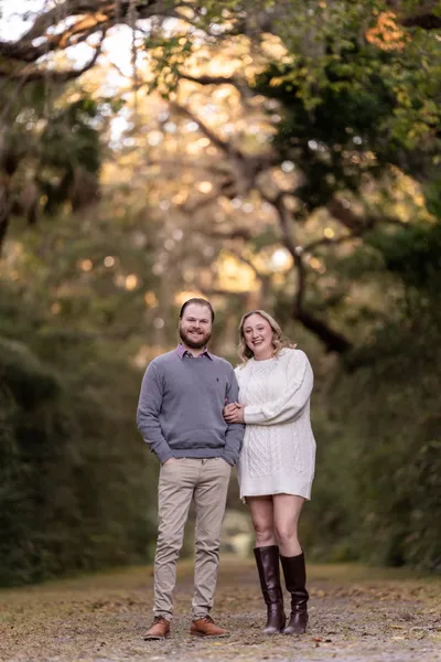 Couple laughing under oak trees at sunset at Washington Oaks State Park