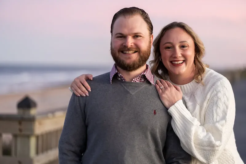 Carli and Jeff portrait on the beach with waves in the background