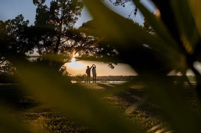 Carli and Jeff dancing silhouette at sunset with Matanzas River in background
