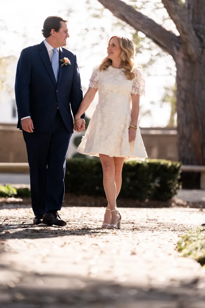 Chauncey and James walking hand in hand through the church courtyard