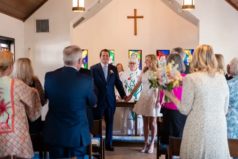 Ceremony at the altar of Christ Church with family standing on both sides