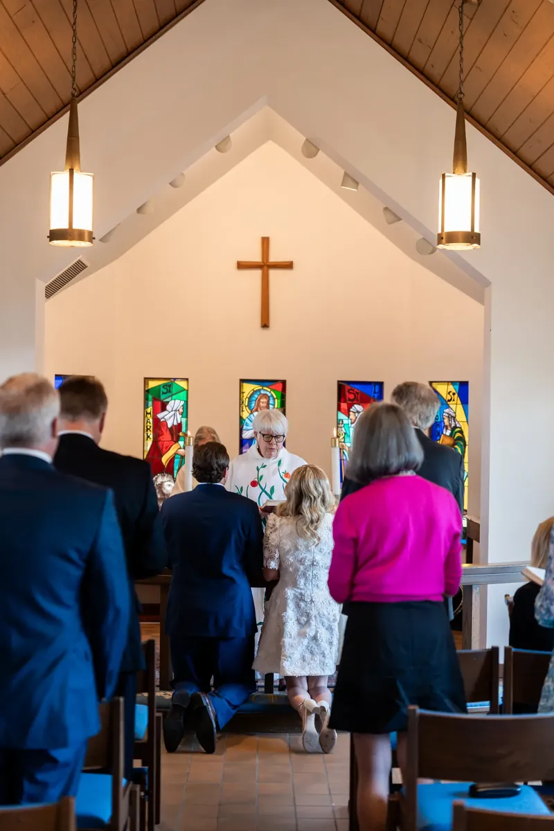 Couple kneeling together at the altar during the ceremony