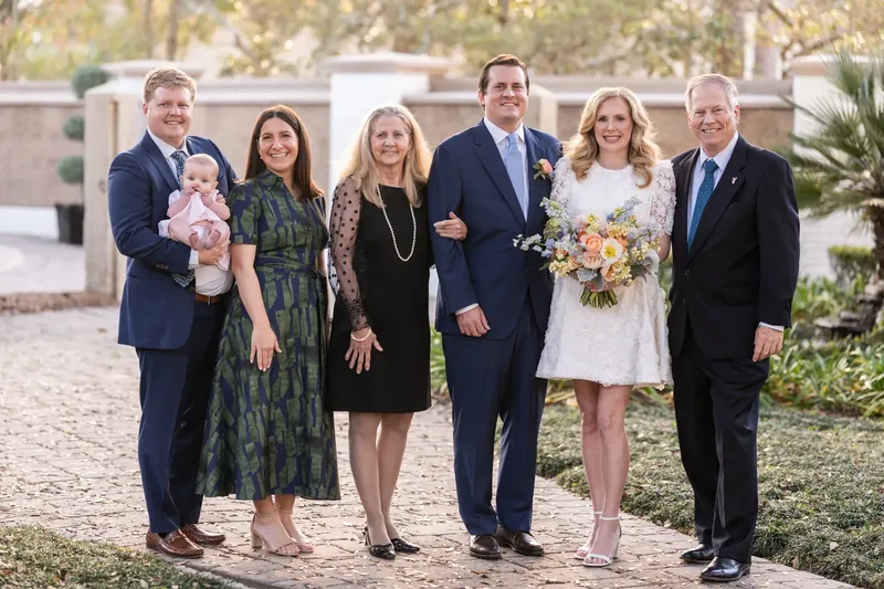 Extended family group portrait in the courtyard at golden hour