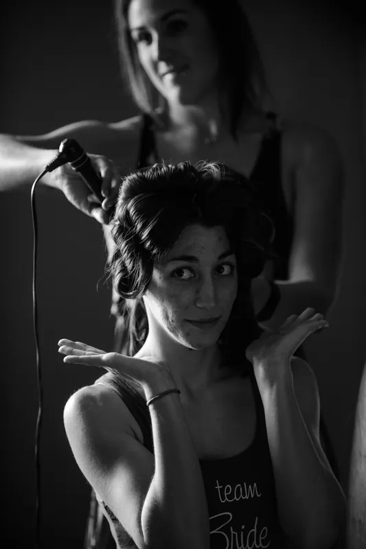 Choko faces the camera with a gentle smile while someone helps adjust her updo hairstyle before the ceremony.
