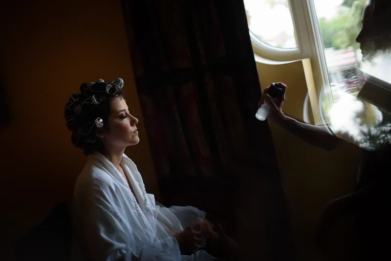 Choko gazes out a window in her white robe, waiting before the ceremony.