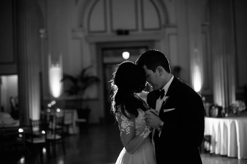 The couple leans in close during an intimate moment in black and white at The Treasury on the Plaza.