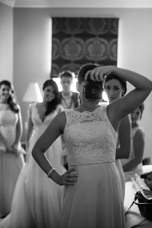Choko adjusts her hair while bridesmaids in flowing dresses watch at Casa Monica Resort & Spa.