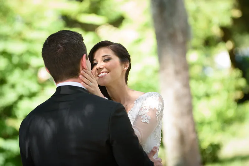 Choko smiles as Michael whispers to her among lush greenery in downtown St. Augustine.