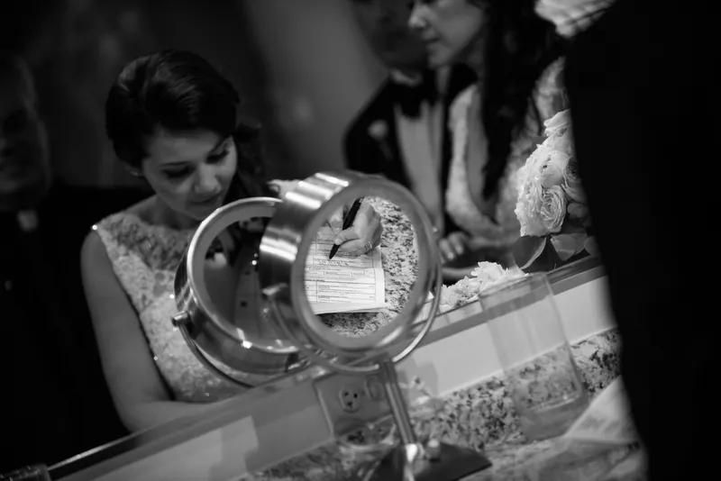 Choko examines ornate rings at The Treasury on the Plaza, St. Augustine, in black and white.