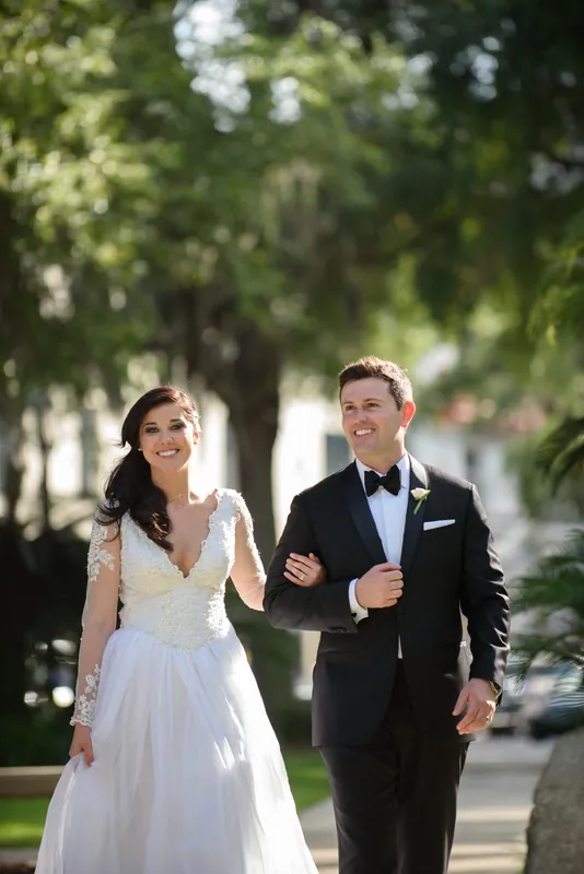 Choko and Michael stroll arm-in-arm under Spanish moss-draped oaks on a Downtown St Augustine street lined with historic
