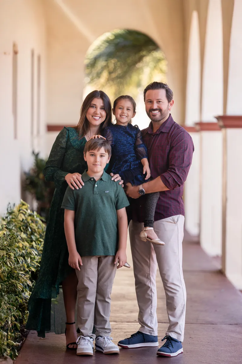 Family portrait in Spanish colonial archway with beautiful golden light