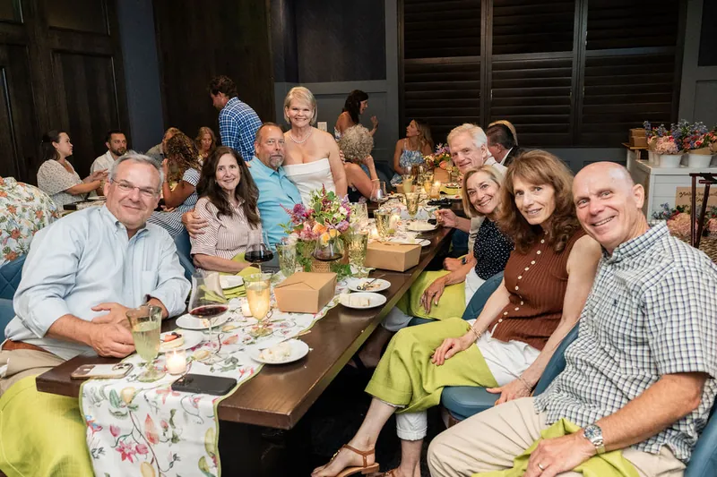 Extended family gathers around a long table at Chophouse at Nocatee, with guests in casual and dressy attire seated among