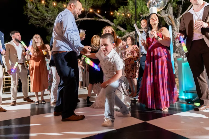 A young child dances on the floor while Von and guests watch during the reception.