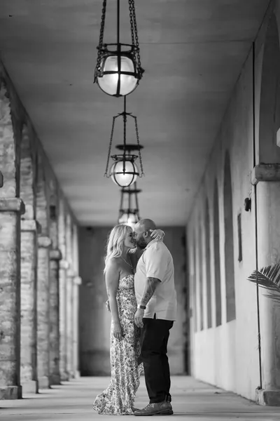 Dee and Tonya kiss under Lightner Museum lanterns