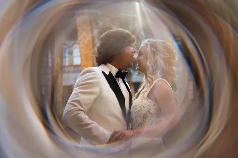 Creative portrait of couple through wedding rings