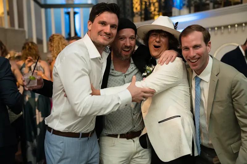 Groom celebrating with friends at reception