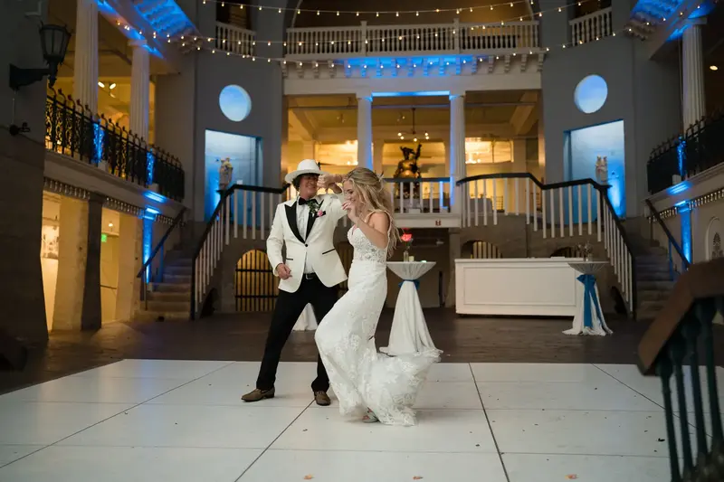 Groom spinning bride on the dance floor at reception