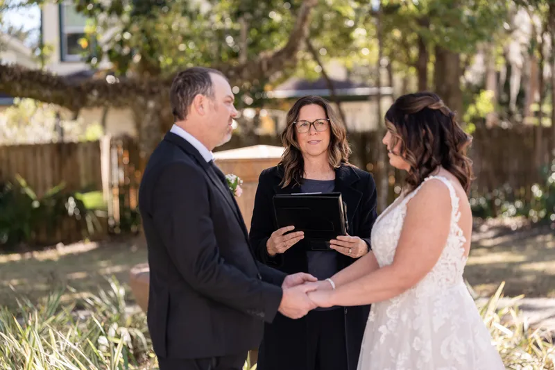 Donnie and Jennifer holding hands during their ceremony with Jilly officiating