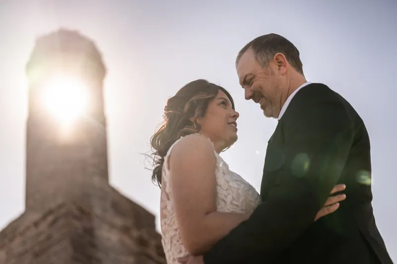 Close-up of Donnie and Jennifer with the Castillo turret and sun flare behind them