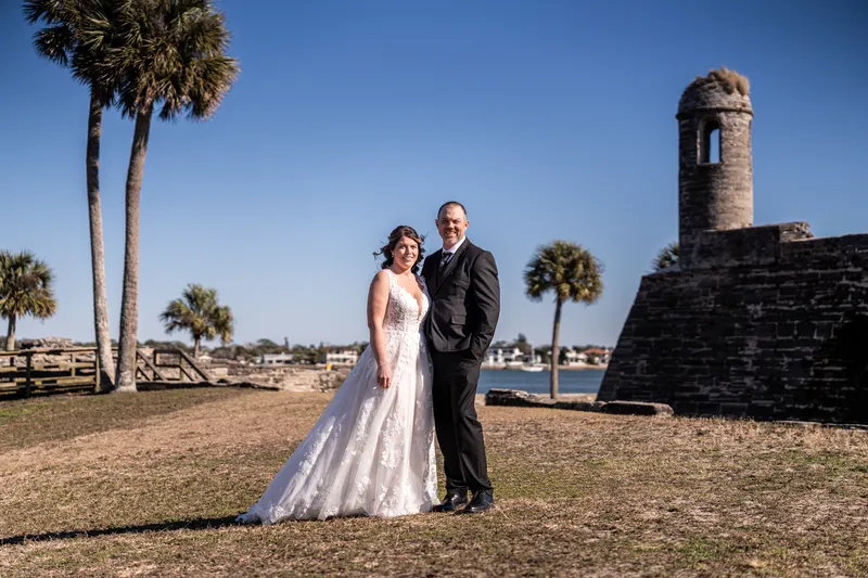 Donnie and Jennifer standing together at the Castillo with the turret and bayfront behind them