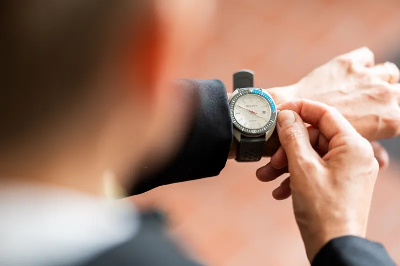 Close-up of groom adjusting his watch before the wedding ceremony