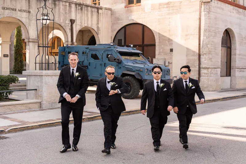 Groom and groomsmen walking in front of the Lightner Museum in St. Augustine