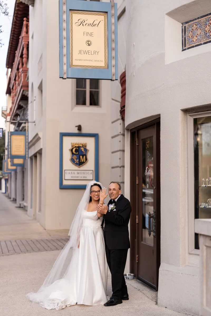 Bride and groom showing off wedding rings outside Reubel Fine Jewelry near Casa Monica