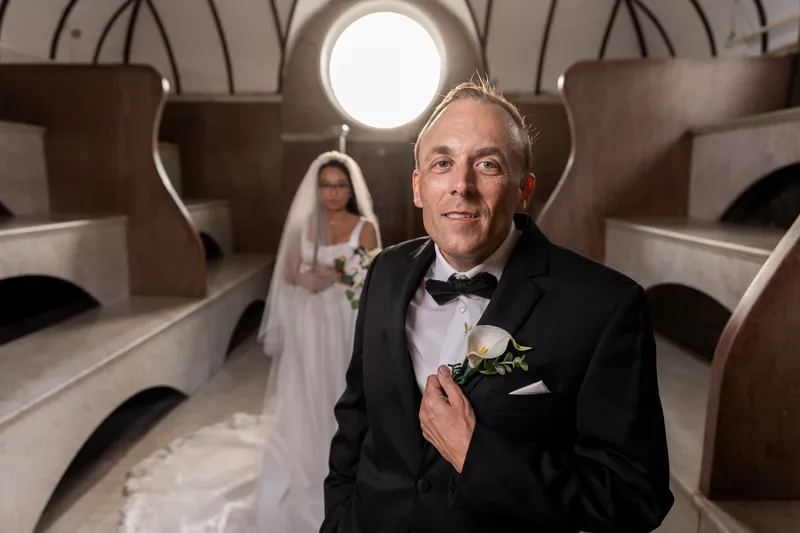 Groom portrait in the Lightner Museum Russian Baths with round window and arched ceiling