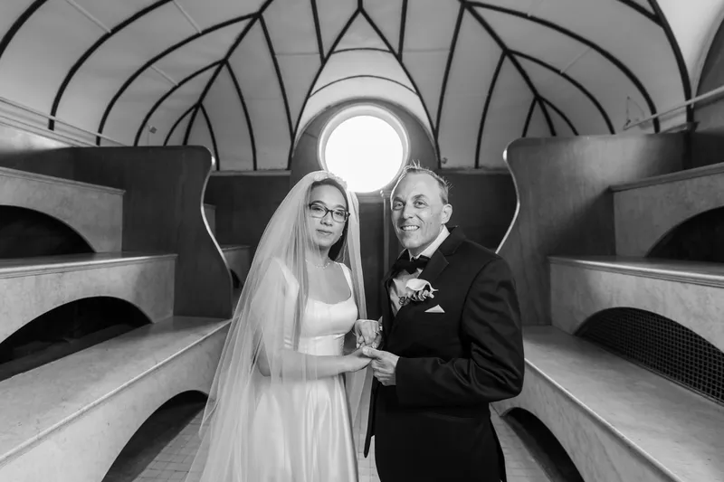 Black and white couple portrait in the Lightner Museum Russian Baths with round window