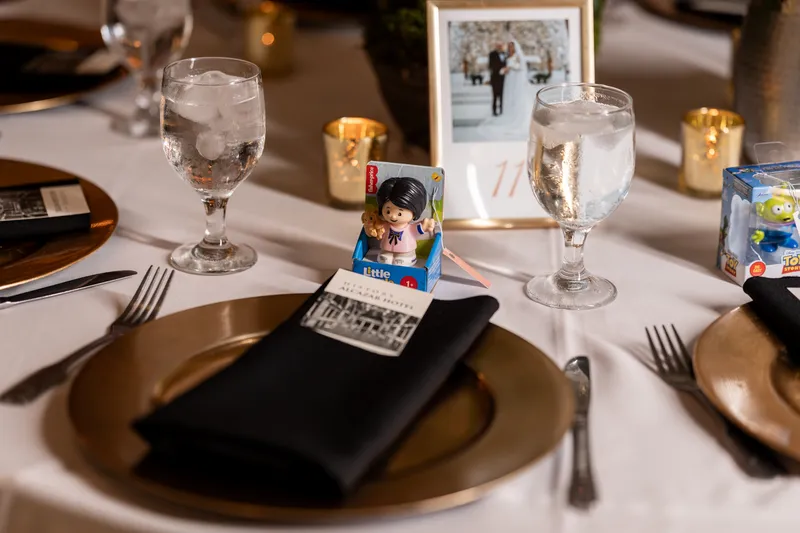 Kids' table setting with Fisher-Price Little People toy favors at each place