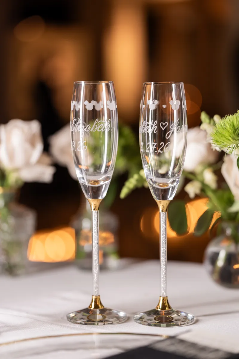 Custom Disney champagne flutes etched with Elizabeth and Jason and Mickey Mouse ears