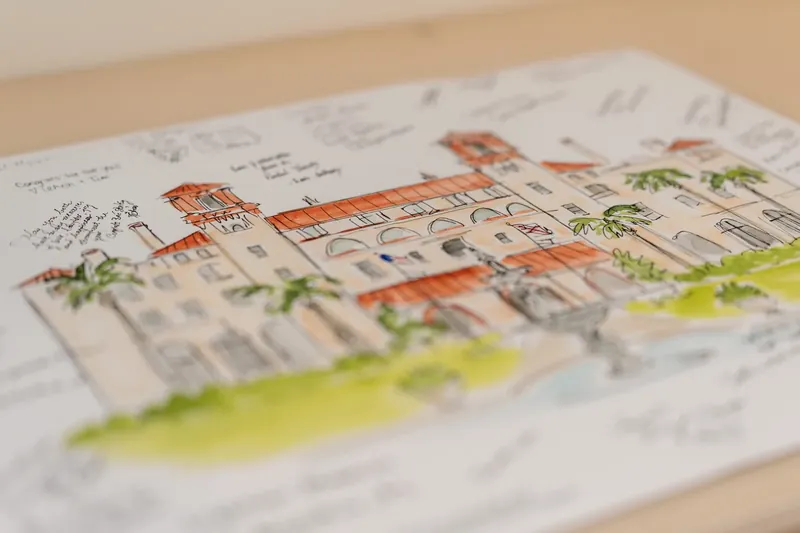 Watercolor illustration of a historic St. Augustine building rendered on white paper with soft green accents.