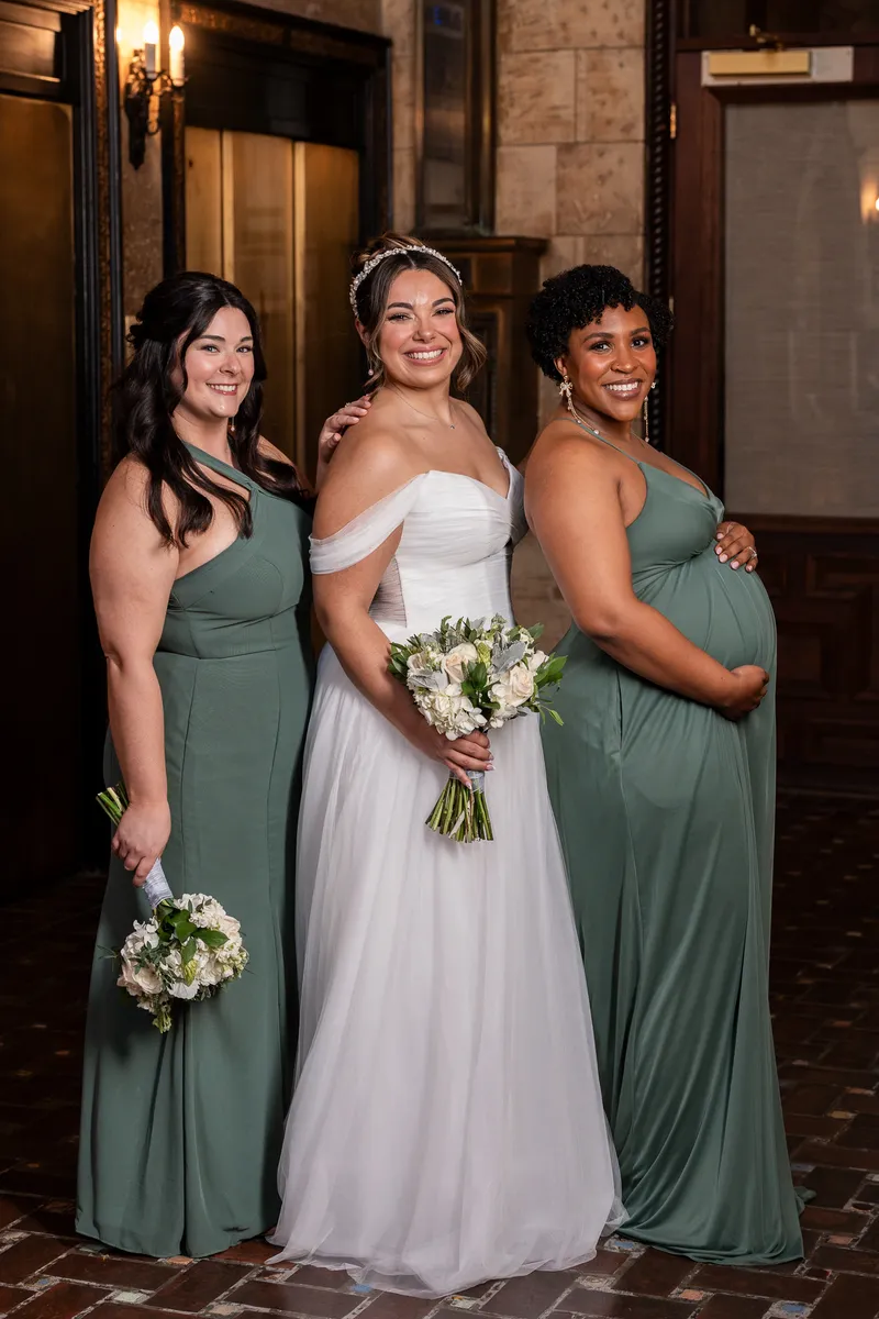 Bride with bridesmaids in sage green dresses at The Treasury