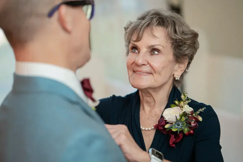 Mother of the groom looking at him with warmth before the ceremony