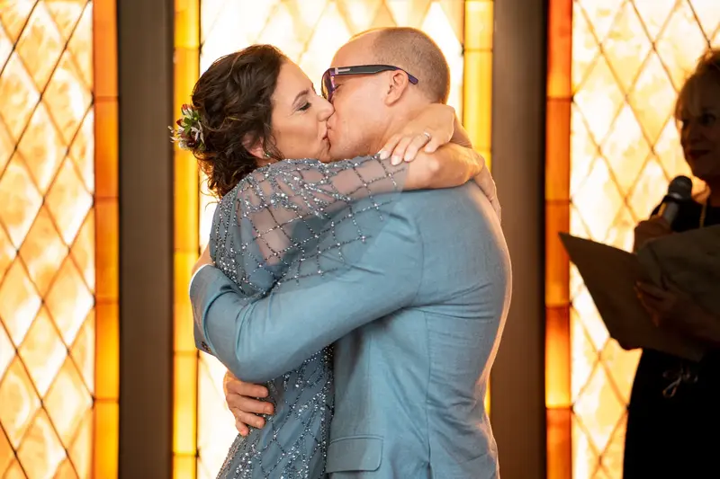 First kiss in front of the glowing stained glass window