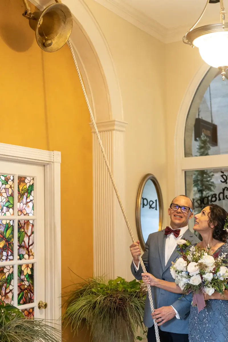 Couple ringing the ceremonial bell together